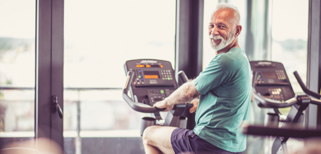 A old man in a stationary bike