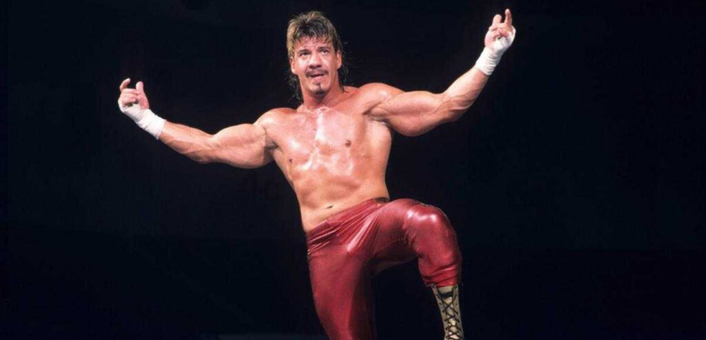 Eddie Guerrero posing on the top turnbuckle.