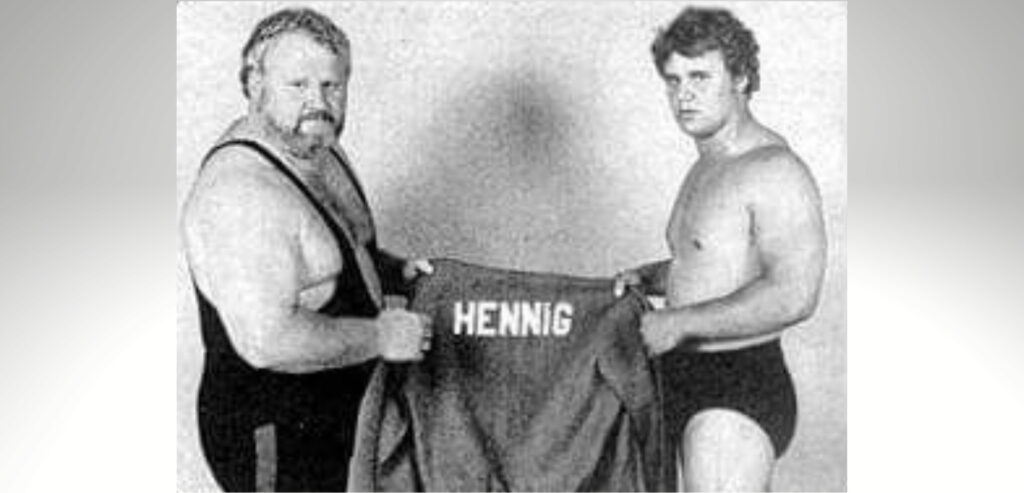 Larry "The Axe" Hennig & Curt Hennig holding a jacket with the name Hennig on it